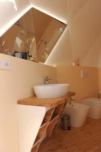 a bathroom with a sink and a toilet at Melograno Bubble Glamping in Vasanello