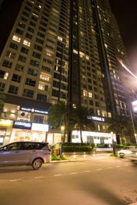 a car parked in front of a large building at night at Liam Service Apartment - Vinhome Central Park in Ho Chi Minh City