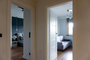 a door leading into a living room with a couch at Apartament Roztocze in Tomaszów Lubelski