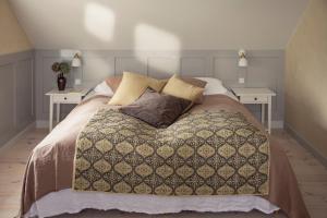 a bedroom with a bed with two side tables at Fanø Krogaard in Fanø