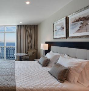 a bedroom with a large bed and a balcony at Miramar By Windsor Copacabana in Rio de Janeiro