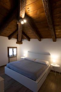 a bedroom with a large bed with wooden ceilings at My home in Venice in Mestre