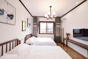 Säng eller sängar i ett rum på Jiamen Inn