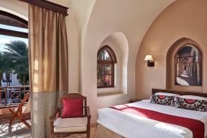 a bedroom with a bed and a balcony at Hotel Sultan Bey Resort in Hurghada
