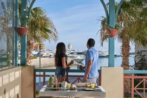 a couple standing on a balcony looking at the marina at Mosaique Hotel El Gouna in Hurghada