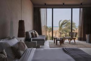 a hotel room with a bed and a view of the ocean at Casa Cook El Gouna - Adults Only in Hurghada