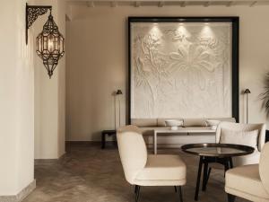 a living room with a couch and chairs and a table at The Chedi El Gouna in Hurghada