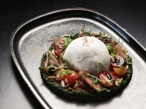 a plate with a dish of food on a table at The Chedi El Gouna in Hurghada