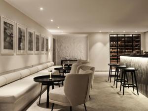 a restaurant with tables and chairs and a bar at The Chedi El Gouna in Hurghada