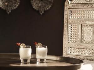 a table with two glasses of milk on a tray at The Chedi El Gouna in Hurghada