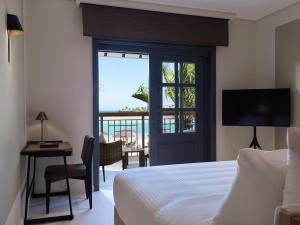 a bedroom with a bed and a view of the ocean at The Chedi El Gouna in Hurghada