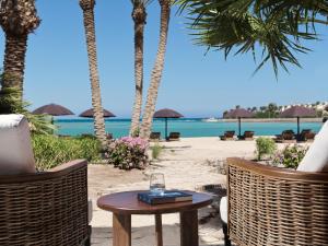 a glass of wine on a table on the beach at The Chedi El Gouna in Hurghada