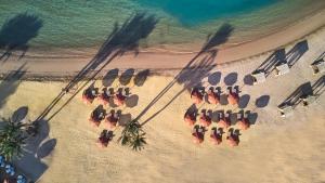 a group of chairs and umbrellas on a beach at The Chedi El Gouna in Hurghada