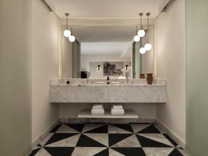 a bathroom with a large sink and a mirror at The Chedi El Gouna in Hurghada