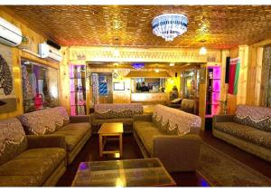 a living room with couches and a chandelier at hotel khalil in Gulmarg