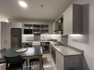 a kitchen with a counter and a table with a plate on it at Stunning 2 Bedroom Apartment in Rosebank Central in Johannesburg