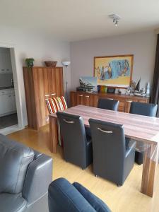- une salle à manger avec une table et des chaises en bois dans l'établissement Residentie Canada, à Blankenberge
