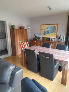 a dining room with a wooden table and chairs at Residentie Canada in Blankenberge