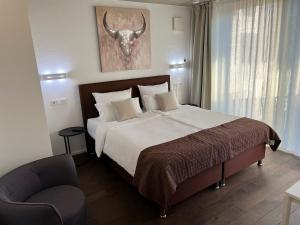 Postel nebo postele na pokoji v ubytování Weingut-Aparthotel Olinger