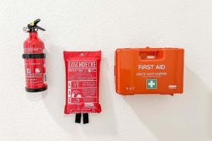 a fire hydrant and a fire extinguisher next to a red fire extinguisher at beautiful 3-room apartment in Wetzlar
