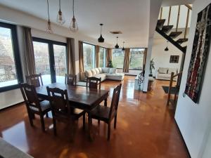 a living room with a wooden table and chairs at Mountain Home Bran in Bran