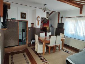 a kitchen and dining room with a table and chairs at Apartman Lara in Krapina