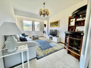 a living room with a couch and a tv at SAN ANTONIO BEACH by Urdaibai rentals in Busturia