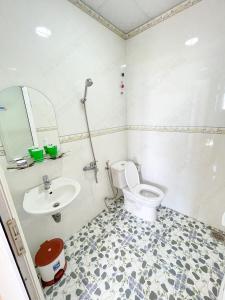 a bathroom with a toilet and a sink at Môn Bạc Home in Da Lat