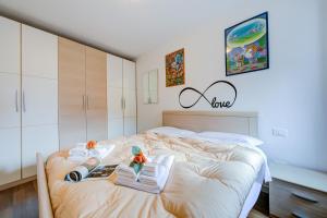 a bedroom with a bed with towels on it at Casa Umberto - Happy Rentals in Tenno