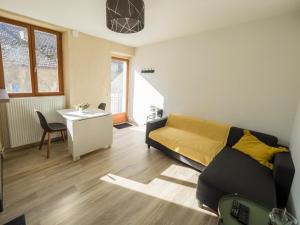 a living room with a couch and a table at Charmant T2 in Aix-les-Bains