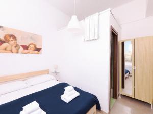 a bedroom with a bed and a painting of babies at Cielo Vaticano Guest House in Rome
