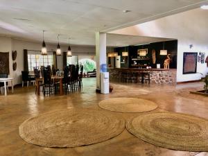 a living room with three large rugs on the floor at Africa House Malawi in Lilongwe