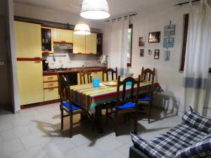 a kitchen and dining room with a table and chairs at Casa Lore al mare in Santa Lucia