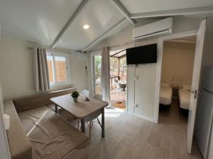 a small living room with a table and a couch at TAIGA Conil in Conil de la Frontera