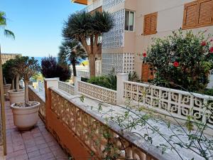 a balcony of a building with trees and plants at Nice Place Santa Pola in Santa Pola