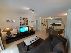 a living room with a couch and a flat screen tv at Luxury Apartment near Cascais Town & Marina in Cascais