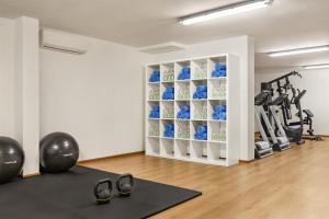a fitness room with a gym with exercise equipment at Wyndham Garden Florence in Florence