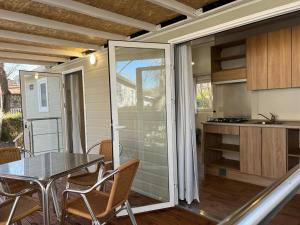 eine Küche und ein Esszimmer mit einem Tisch und Stühlen in der Unterkunft Bungalows & Albergue La Playa in Logroño