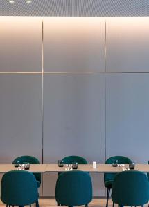 a conference room with tables and green chairs at HVD Reina del Mar - Premium Spa Service & Free Parking in Obzor