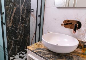a bathroom with a bowl sink and a shower at Cetin Port Hotel in Istanbul