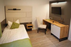 Postel nebo postele na pokoji v ubytování Hotel und Restaurant Kranichsberg