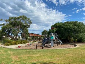a playground with a slide in a park at Seafoam, Cowes, New Home, Fast NBN WIFI in Cowes