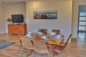 a dining room with a table and chairs at Seafoam, Cowes, New Home, Fast NBN WIFI in Cowes
