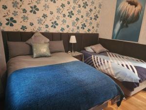 a bedroom with two beds and a blue blanket at Boutique style accomodation near Busselton Jetty in Busselton