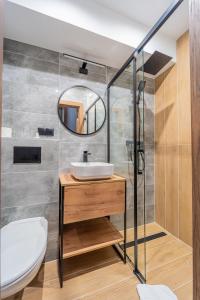 a bathroom with a sink and a mirror at Hotel Polski in Mielec