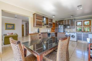 a kitchen and dining room with a table and chairs at San Lameer Villa 10415 - 2 Bedroom Classic - 4 pax - San Lameer Rental Agency in Southbroom