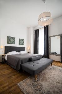 a bedroom with a large bed and a large window at Emporikon Athens Hotel in Athens
