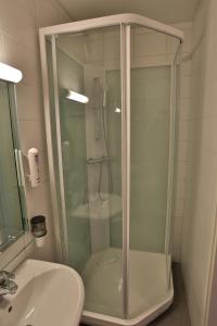 uma cabina de duche em vidro na casa de banho com um lavatório em Ylläs Lake Hotel em Ylläsjärvi