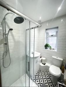 a bathroom with a shower and a toilet and a sink at Large Walton House - EFC & LFC in Liverpool