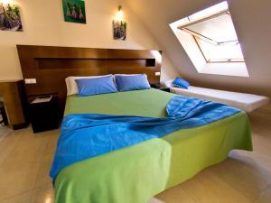 A bed or beds in a room at Hostal San Marcos